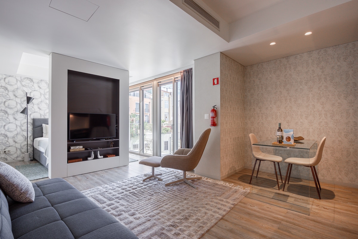 Living and dining area with glass table, bedroom beyond