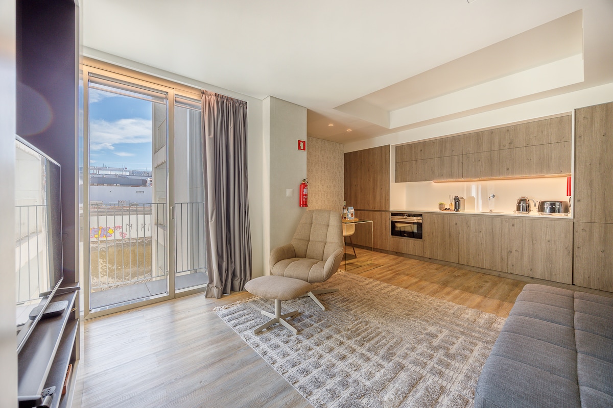 Balcony doors, lounge chair and the open kitchen