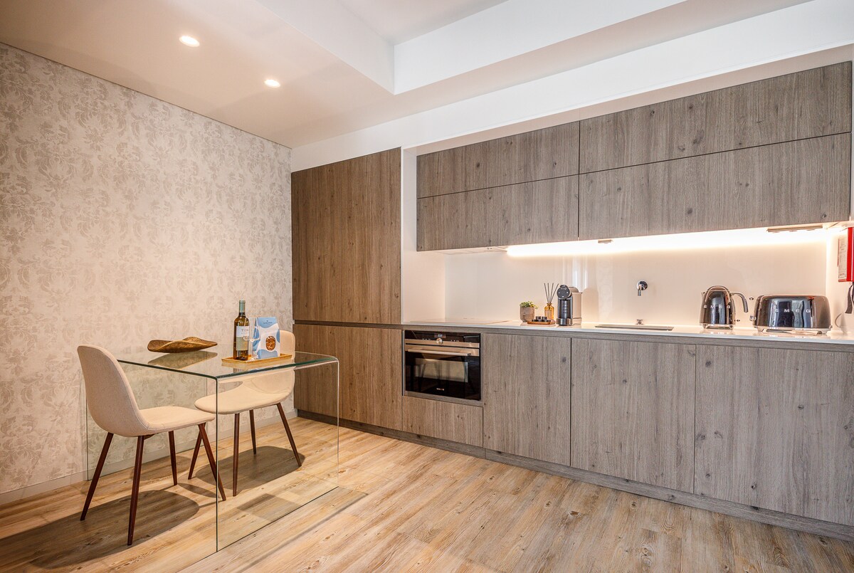 Kitchen with oven, kettle, toaster and dining table for two